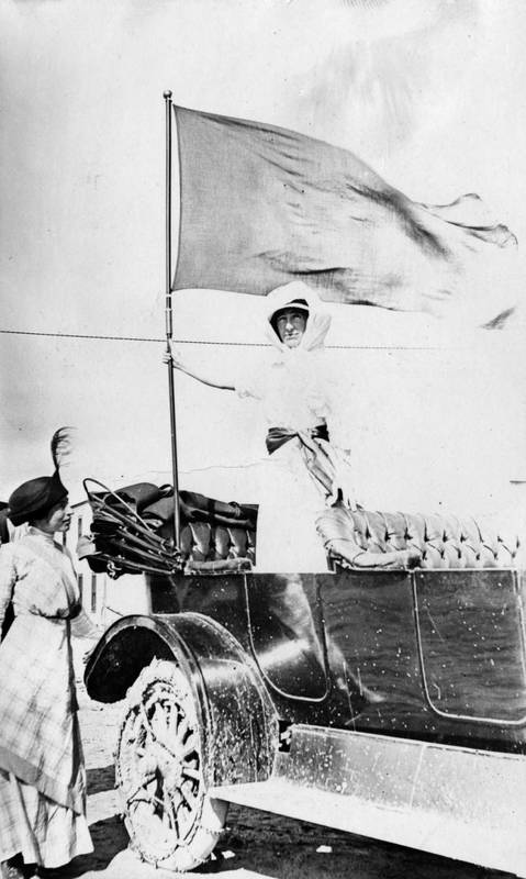 Jeannette Rankin holding a suffrage banner