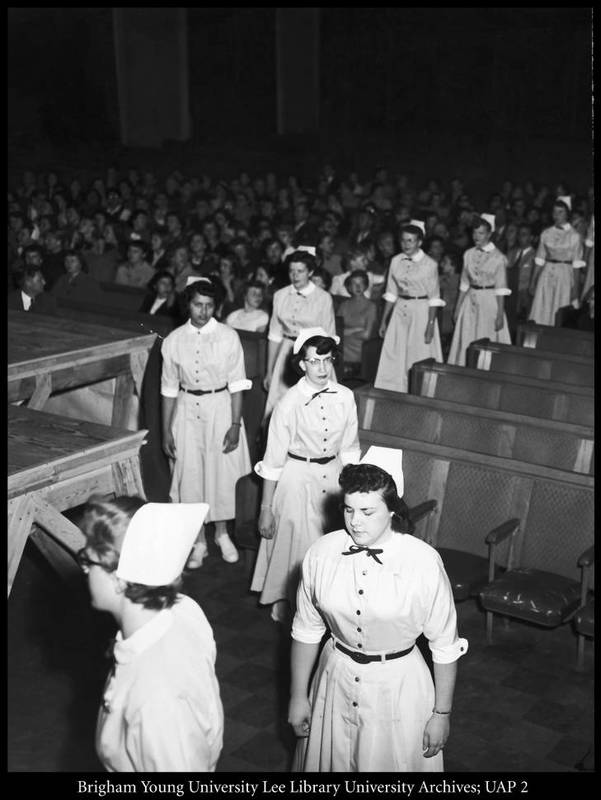 Students in the College of Nursing participate in a program and reception, 1950s