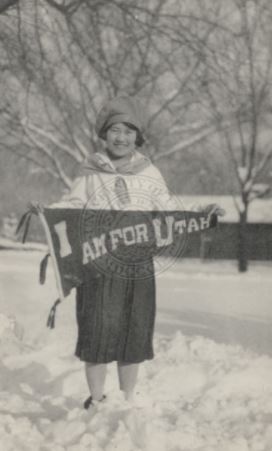 A Japanese girl holding up a sign supporting Utah.