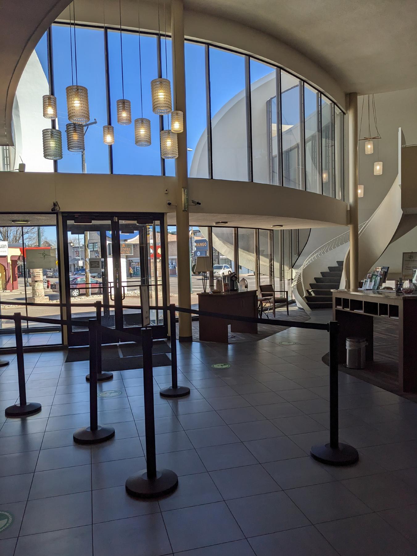 The interior of the Key Bank, with the twisting staircase to the second floor visible in the far right.