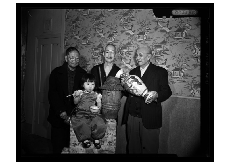 A Chinese family gathers for a picture in a Plum Alley Building.<br />