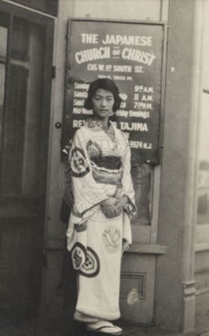 A woman ready to go to church dressed in a kimono. <br />