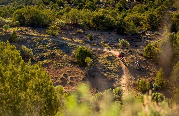 Mountain Biker Navigates Sweeping Right Turn, Sunset
